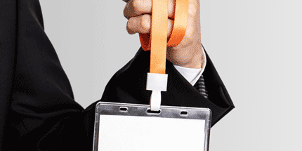 suit holding a lanyard with card holder