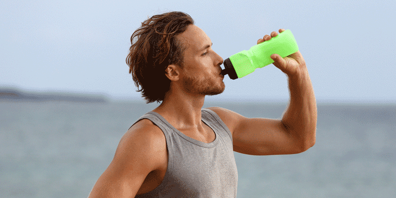 man drinking water from water bottle