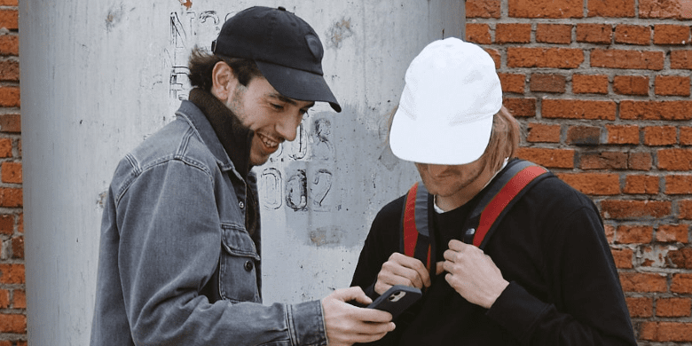 two skateboards wearing caps