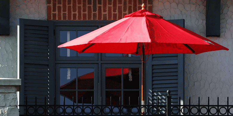 red beach umbrella on hotel balcony red beach umbrella on hotel balcony