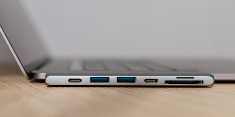 A laptop with a USB hub plugged into it.