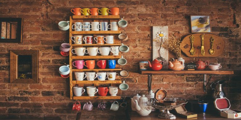 An entire cupboard/shelf of mugs and cups.