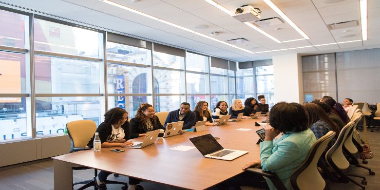 A meeting taking place in a boardroom or conference room.