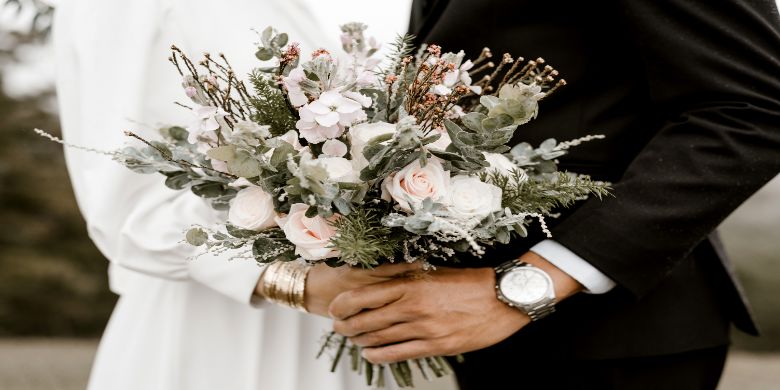 A wedding couple holding their bouquet