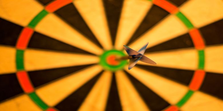 A dart that has landed on the bulls-eye on a dart board