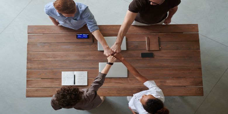 People fist-bumping after a meeting.