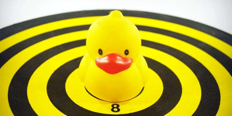 Yellow Rubber Duckie on Dart Board