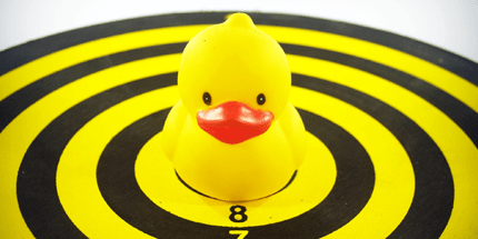 Yellow Rubber Duckie on Dart Board