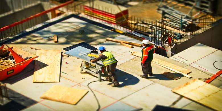 A construction worker wearing hi-vis clothing on a worksite.