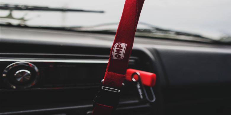 A lanyard inside of a car.