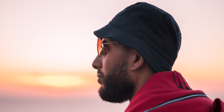 man wearing bucket hat in sun