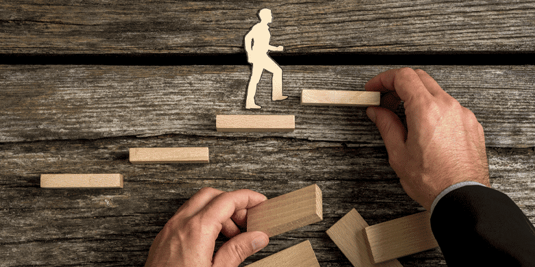 Silhouette cutouts of a man walking up steps