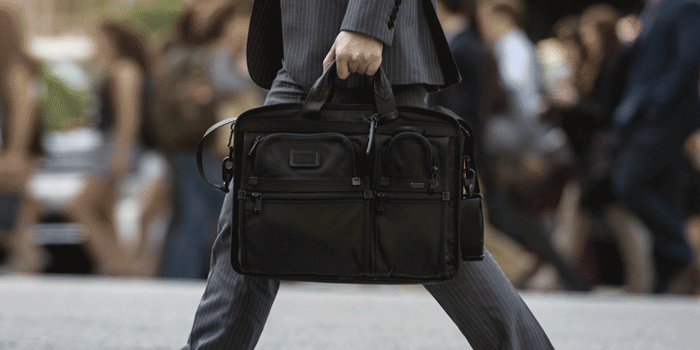 man walking with laptop bag