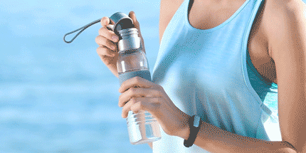 woman holding metal water bottle