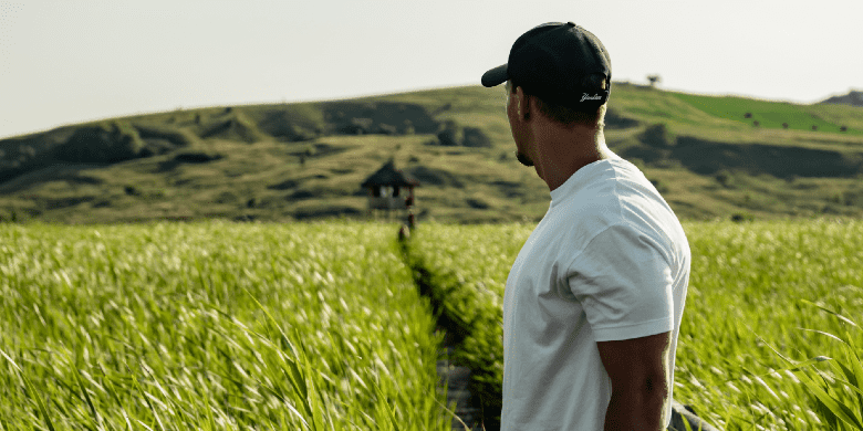 man wearing cap looking at horizon