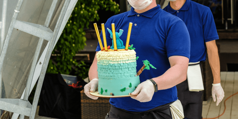 restaurant waiters carry cake