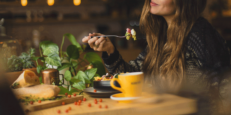 woman eating drinking at restaurant