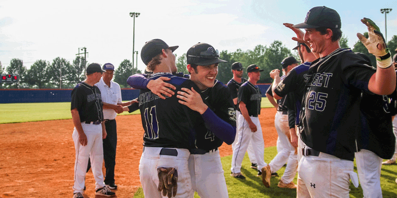 baseball team wearing caps and hugging