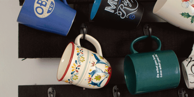 mugs hung on wall hooks