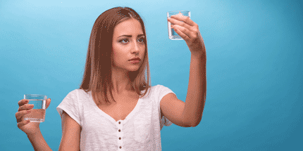 holding two glasses of water