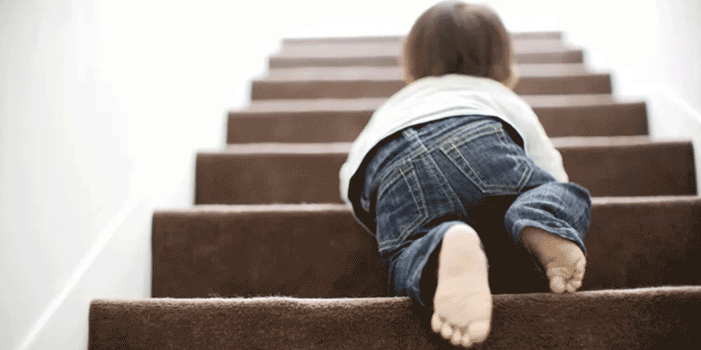 small child walking up stairs