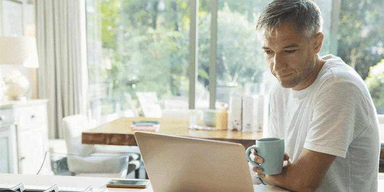 man working from home with mug