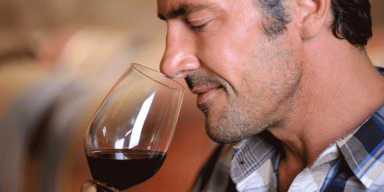 man smelling wine